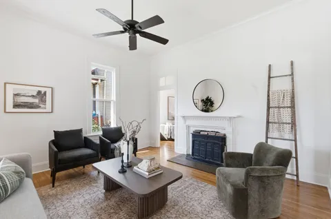 a living room with furniture a fireplace and a table