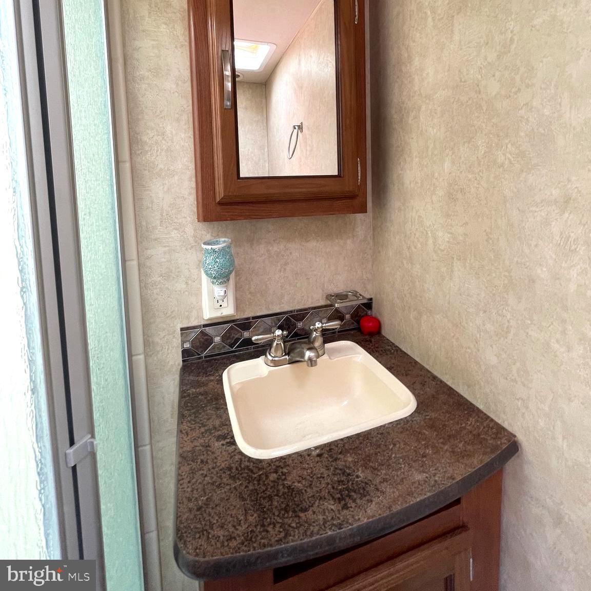 52 Block Butterfly Boulevard Falling Waters, WV 25419 - Photo 13 of 23 a bathroom with a sink and a mirror