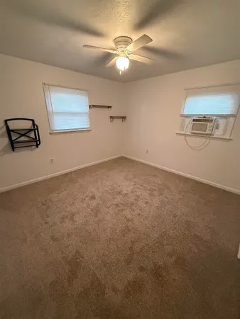 an empty room with a fan and a fan