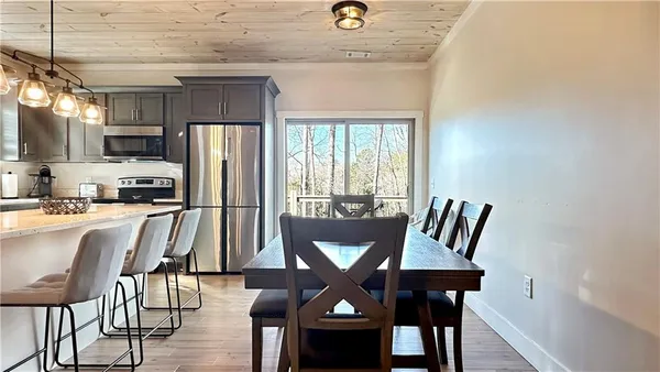 a view of a dining room with furniture window and wooden floor