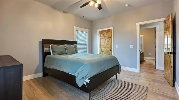 a bedroom with a bed and wooden floor