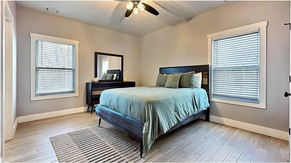 a bed sitting in a bedroom next to a window