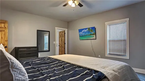 a bedroom with a bed and a chandelier