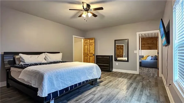 a bedroom with a large bed and a chandelier