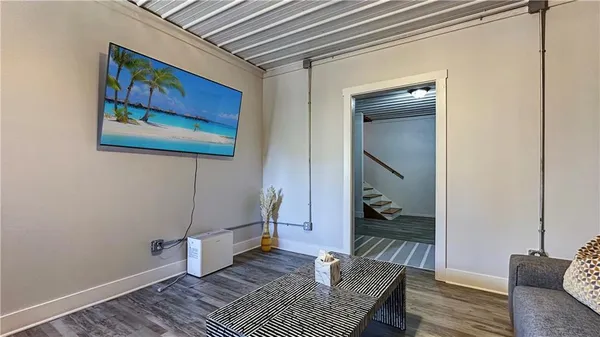 a living room with furniture and wooden floor