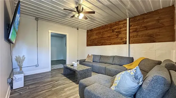 a living room with furniture and a wooden floor