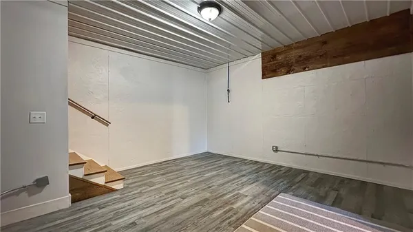 a view of a room with wooden floor