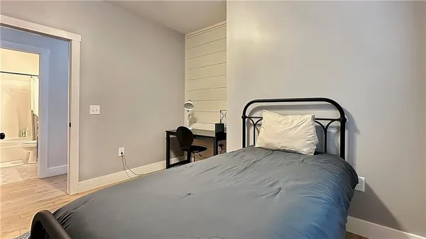 a bedroom with a bed and a chair