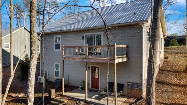 a backyard of a house with wooden fence and trees