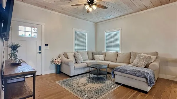 a living room with furniture and a chandelier