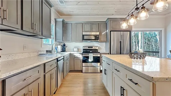 a kitchen with stainless steel appliances kitchen island granite countertop a sink and cabinets