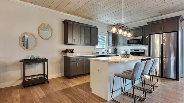 a kitchen with a refrigerator a sink and cabinets