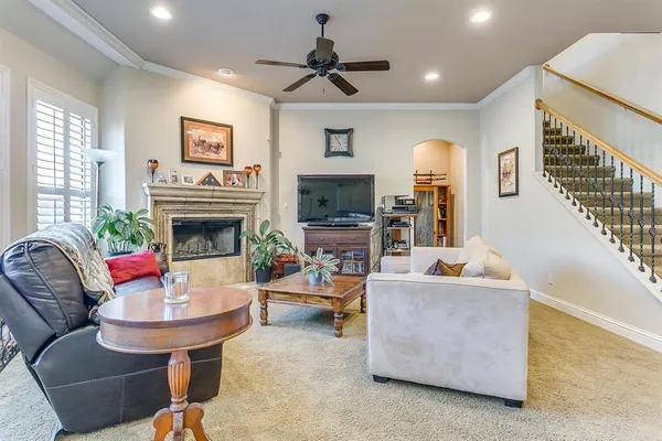 a living room with furniture a fireplace and a flat screen tv