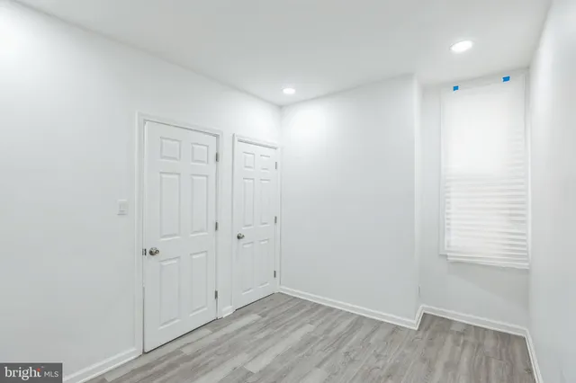 a view of a room with wooden floor and white walls