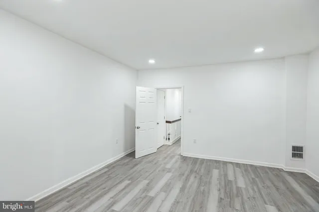 a bedroom with a large bed and a painting on the wall