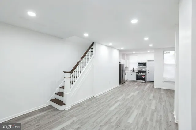 a kitchen with stainless steel appliances a refrigerator stove and microwave