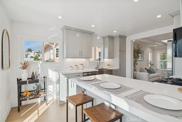 a bed sitting in a spacious bedroom next to a window