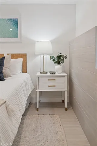 a spacious bedroom with a bed and a cabinets
