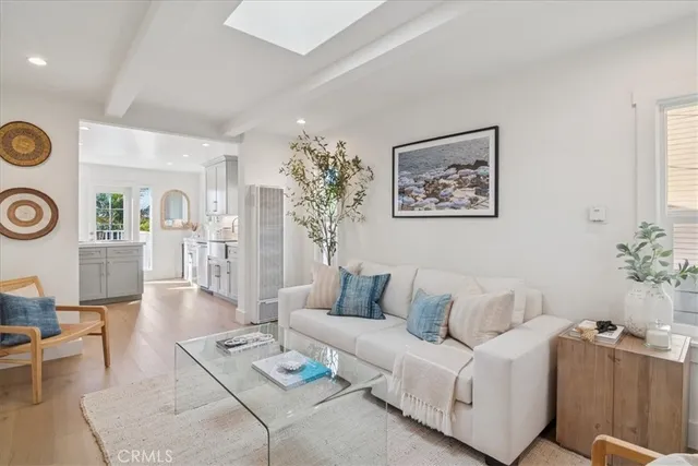 a living room with furniture a clock and a large mirror