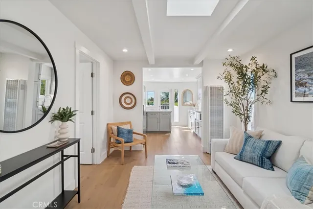 a living room with furniture a rug a clock and a large window