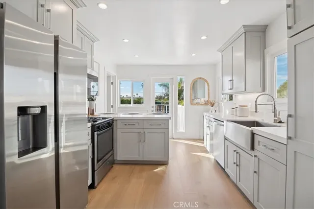 a kitchen with white cabinets and a sink
