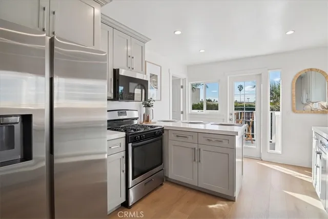 a kitchen with a table chairs stove and white cabinets