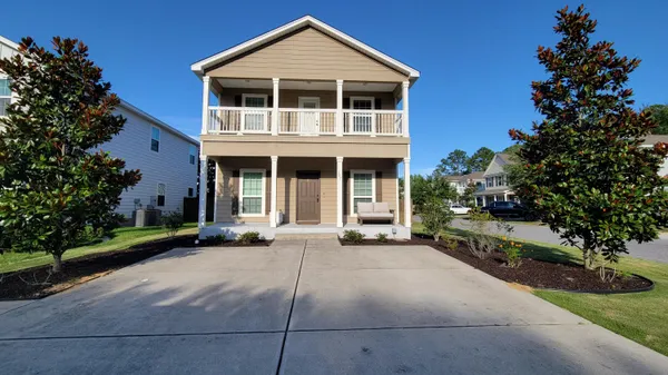 a front view of a house with a garden