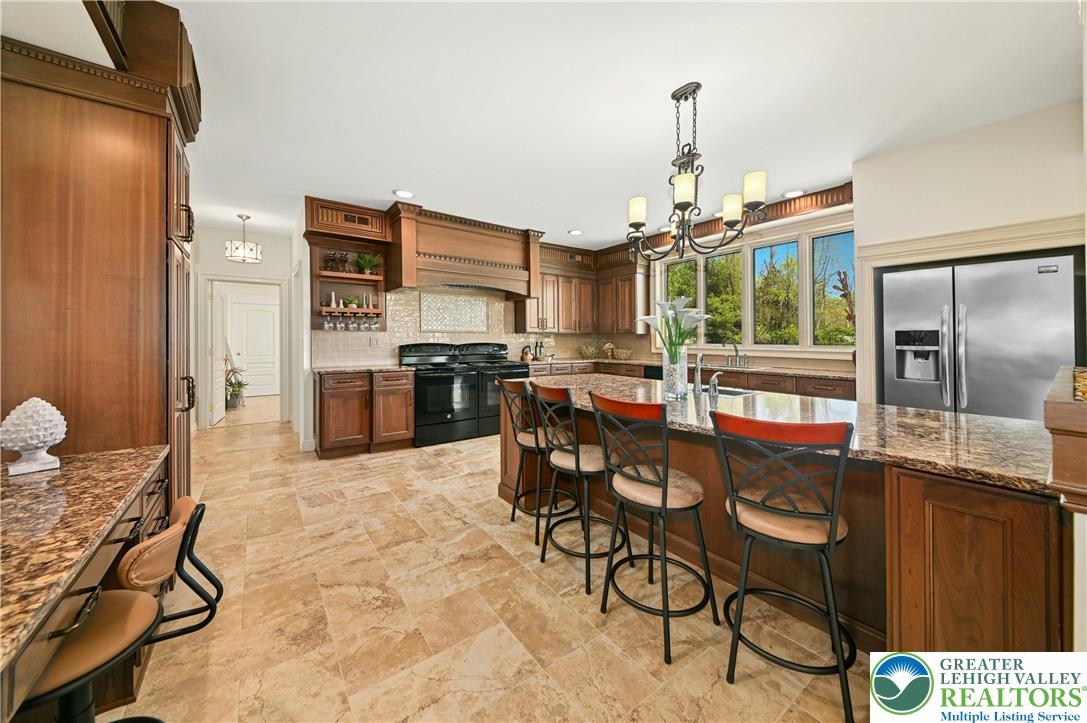 3200 Creamery Road New Hope, PA 18938 - Photo 11 of 42 a kitchen with stainless steel appliances kitchen island granite countertop a table and chairs in it