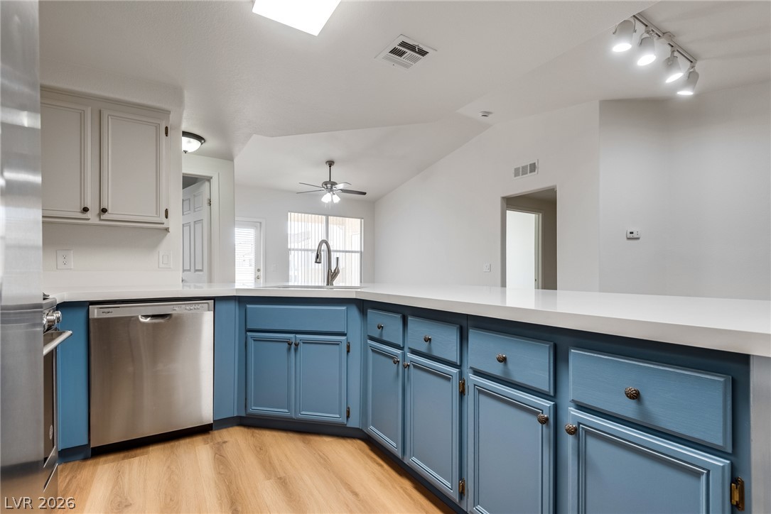 10550 West Alexander Road, Unit 2174 Las Vegas, NV 89129 - Photo 8 of 28 Warm wood flooring contrasts beautifully with crisp solid countertops and stylish cabinetry.