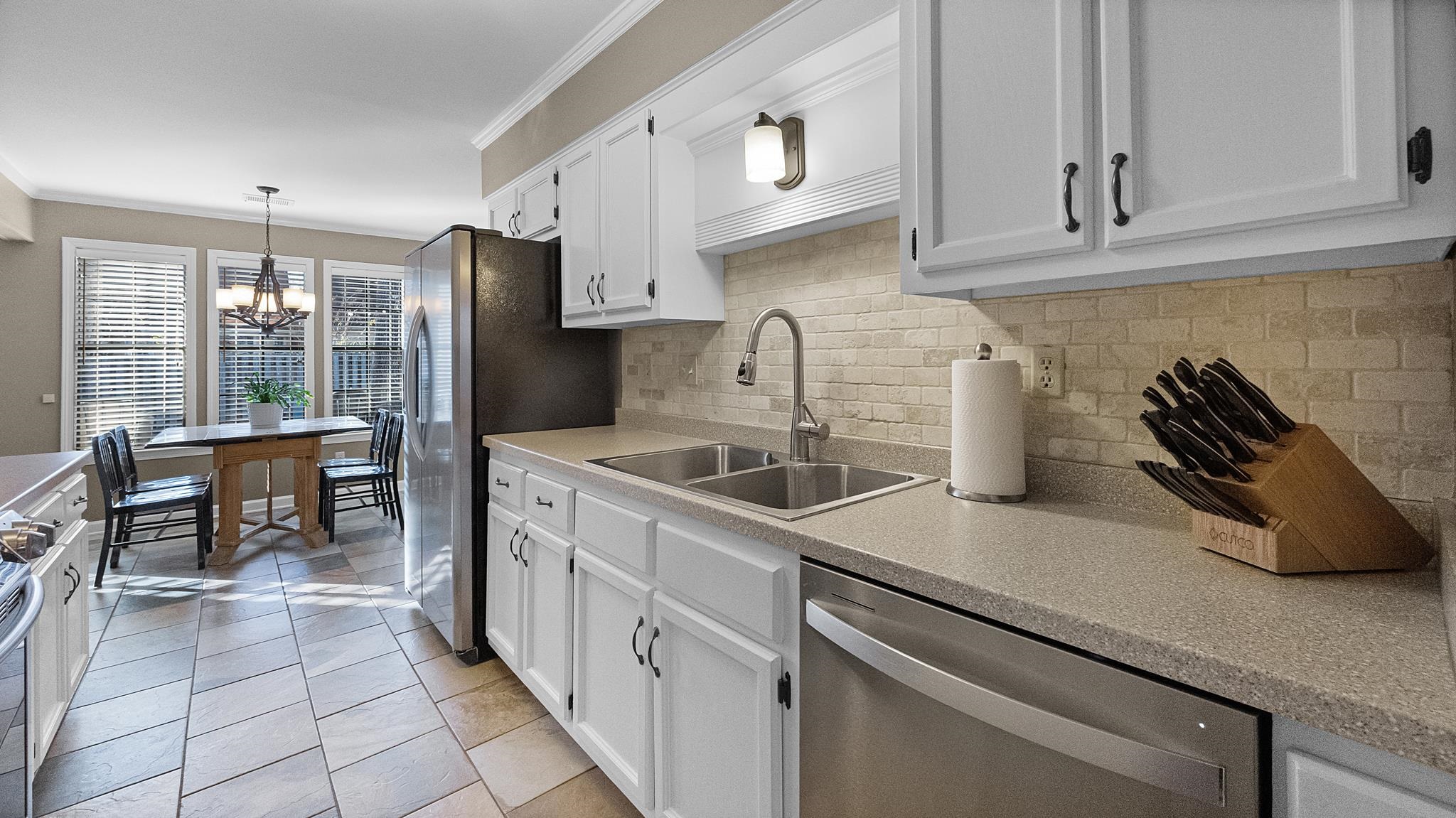 1883 Edwards Mill Road Germantown, TN 38139 - Photo 13 of 40 a kitchen with a sink and cabinets