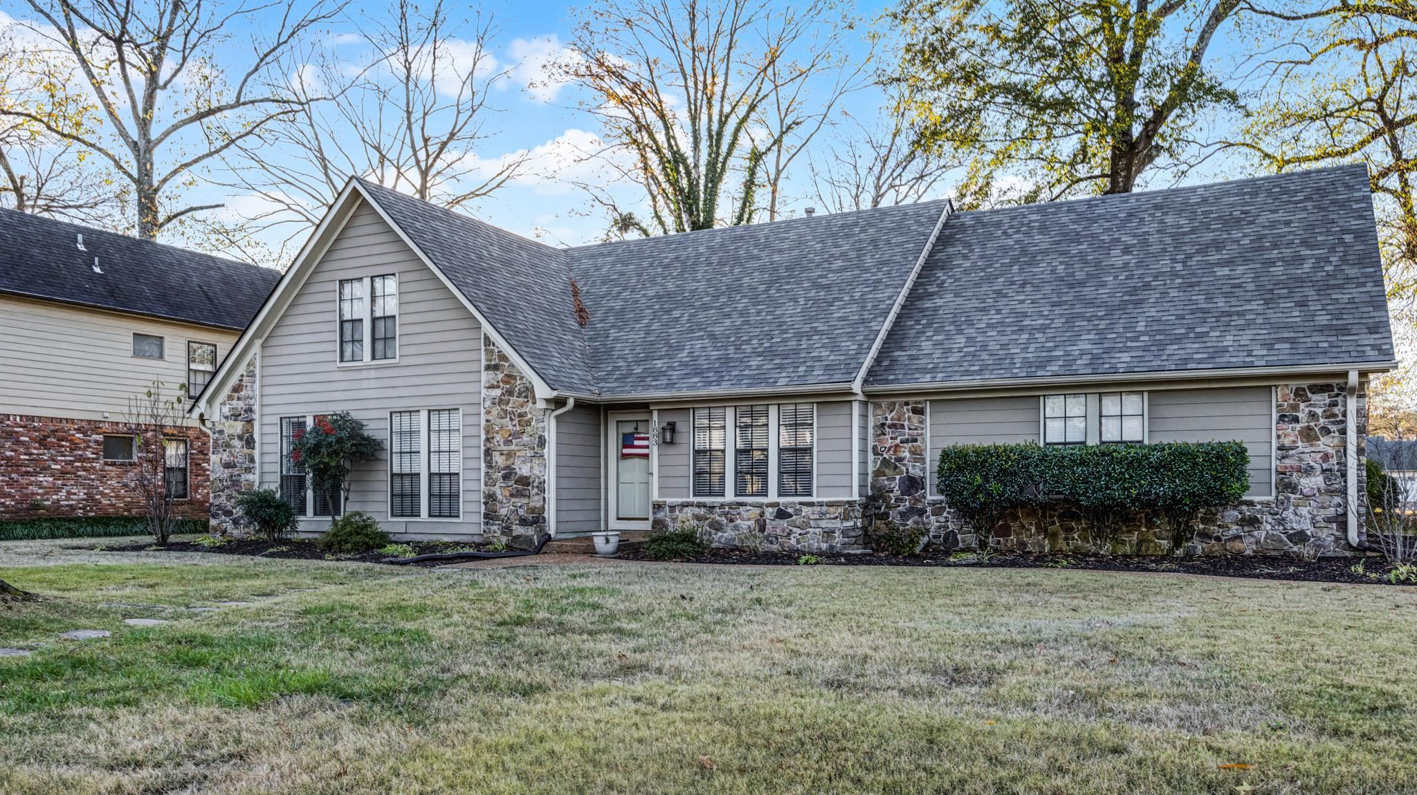 1883 Edwards Mill Road Germantown, TN 38139 - Photo 2 of 40 a front view of a house with a garden