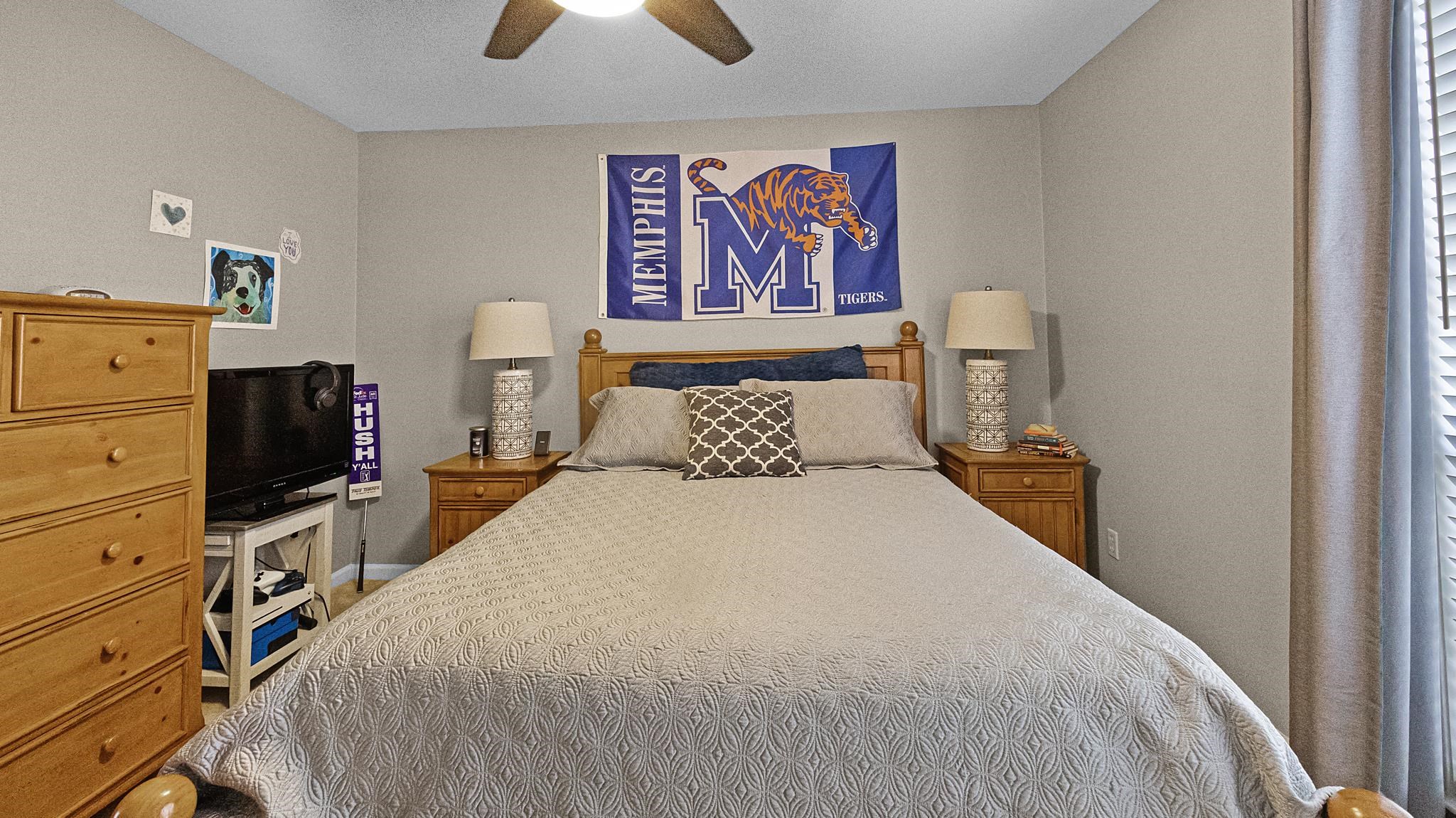 1883 Edwards Mill Road Germantown, TN 38139 - Photo 23 of 40 a bedroom with a bed and a flat screen tv