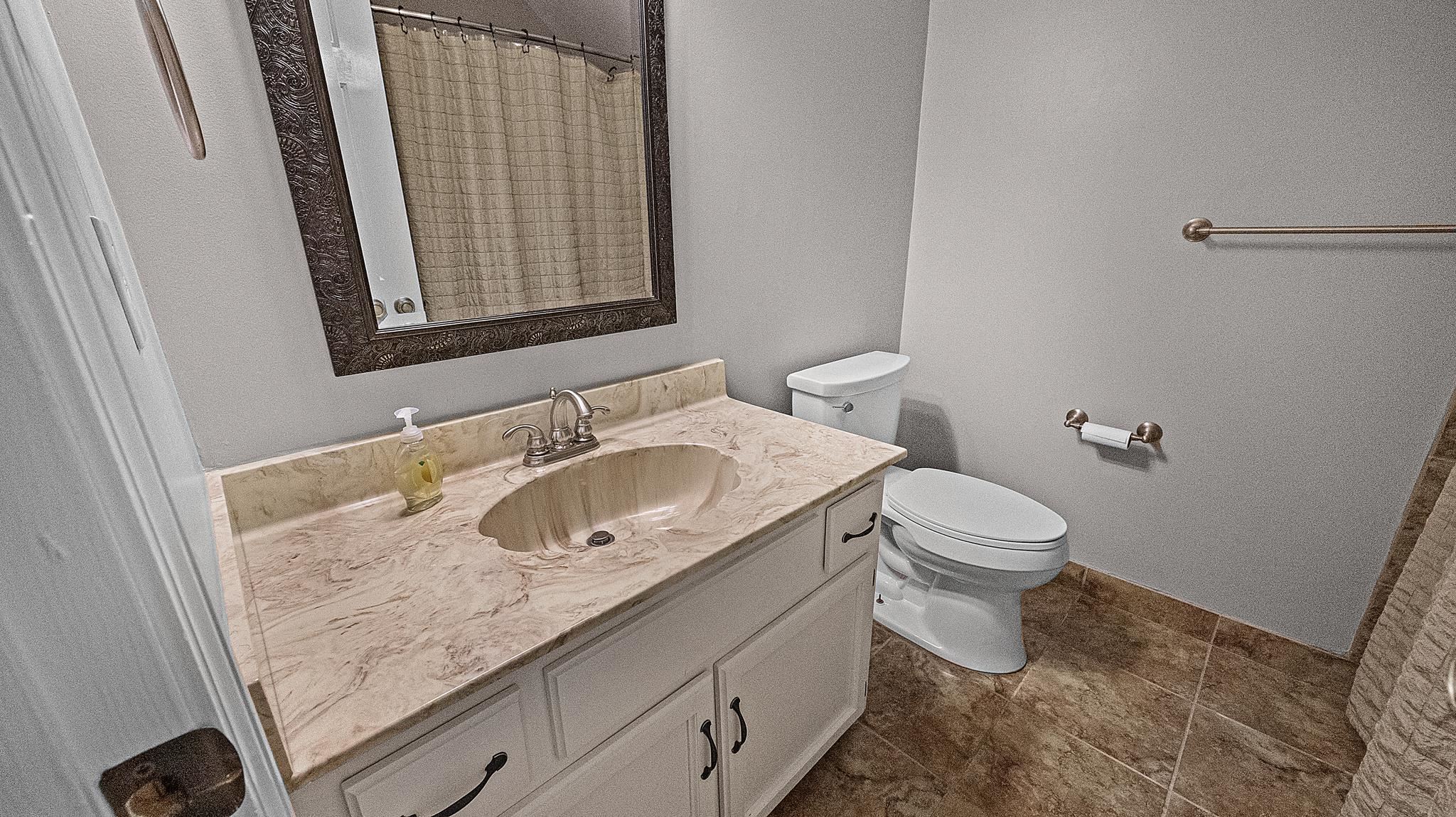 1883 Edwards Mill Road Germantown, TN 38139 - Photo 32 of 40 a bathroom with a granite countertop sink toilet and mirror
