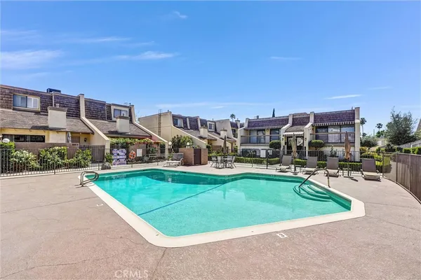 a swimming pool with outdoor seating and yard