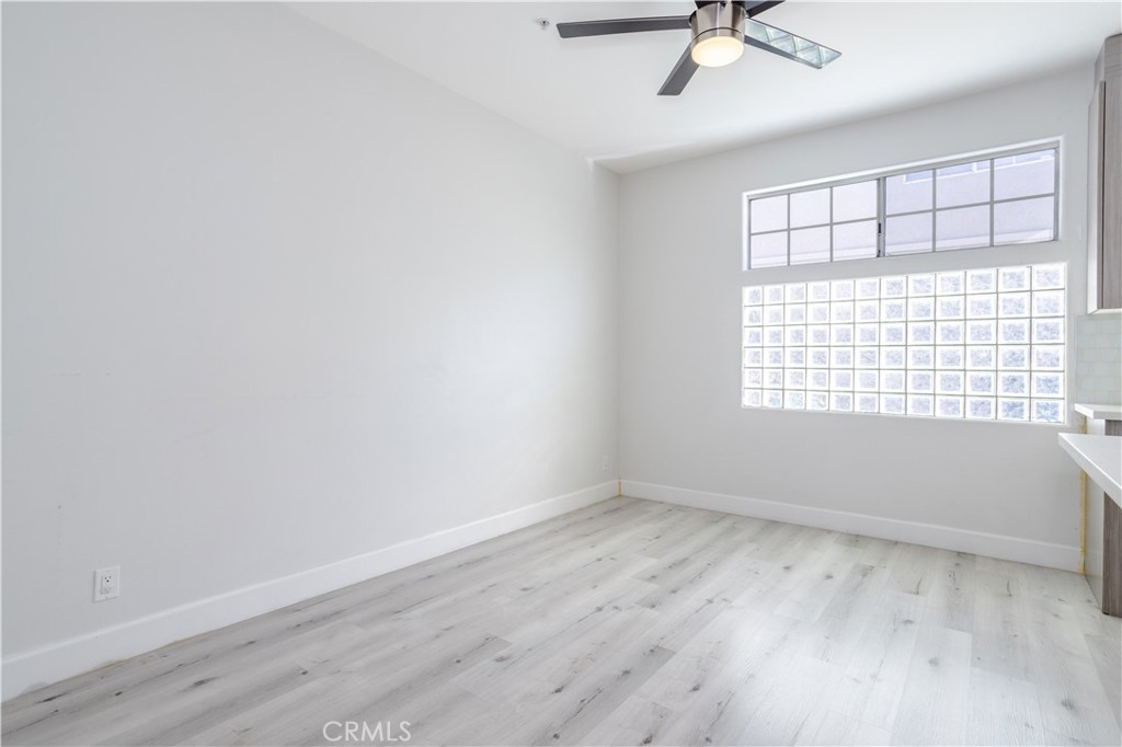18347 Saticoy Street, Unit 28 Reseda, CA 91335 - Photo 13 of 27 wooden floor in an empty room with a window