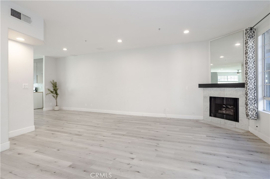 18347 Saticoy Street, Unit 28 Reseda, CA 91335 - Photo 5 of 27 a view of empty room with wooden floor and fireplace