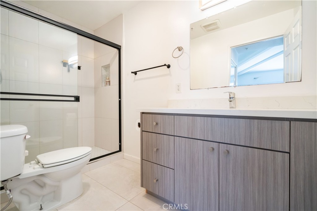 18347 Saticoy Street, Unit 28 Reseda, CA 91335 - Photo 6 of 27 a bathroom with a toilet a sink and a mirror