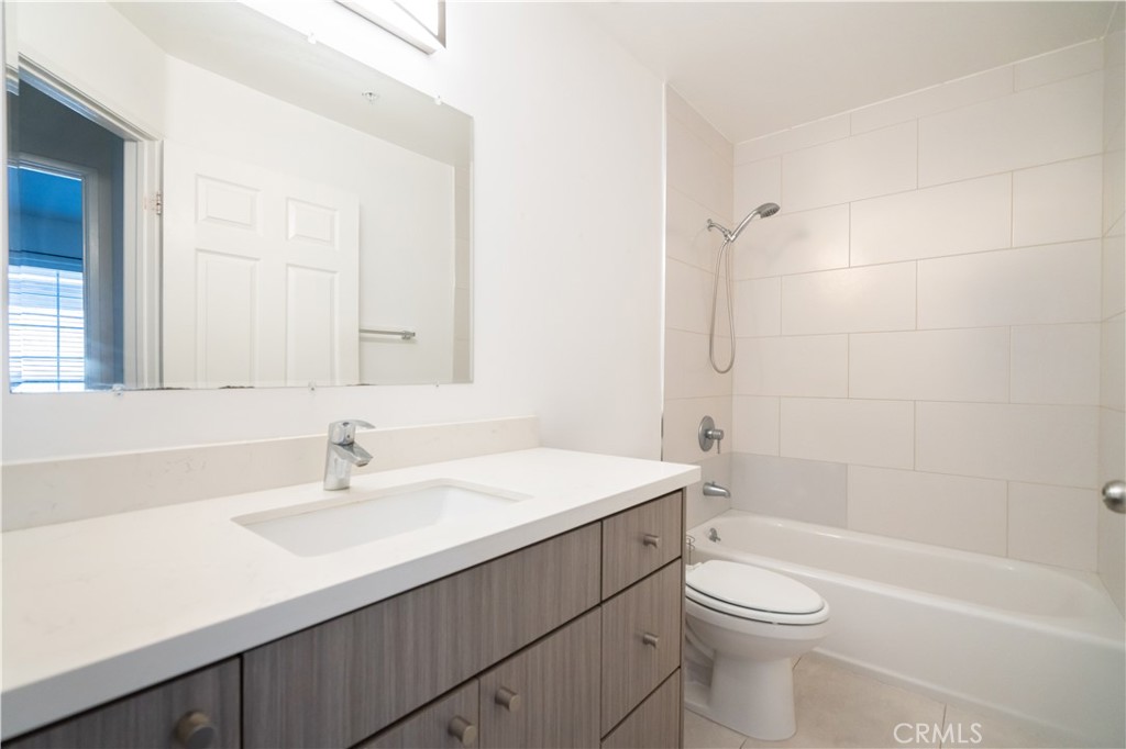 18347 Saticoy Street, Unit 28 Reseda, CA 91335 - Photo 8 of 27 a bathroom with a sink a toilet and shower