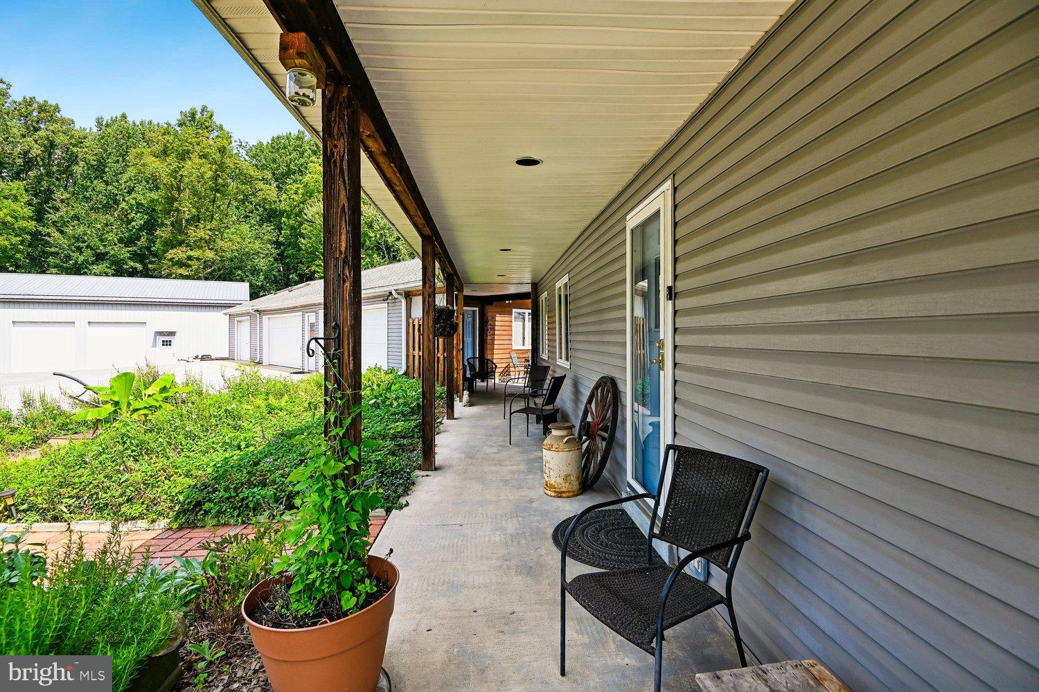 18 Watergate Court Silver Spring, MD 20905 - Photo 1 of 82 Charming porch with lush greenery backdrop.