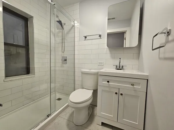 a bathroom with a sink toilet and shower