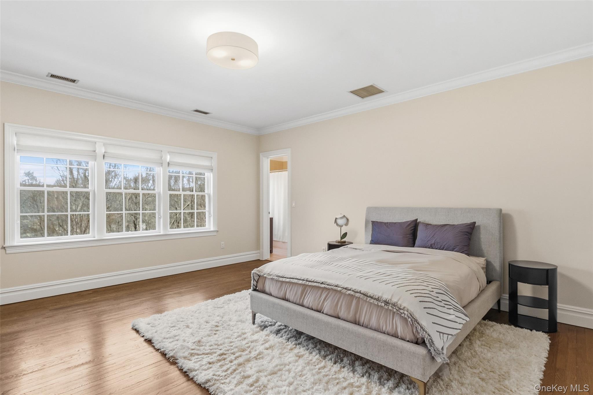 241 North Salem Road Waccabuc, NY 10597 - Photo 31 of 48 a spacious bedroom with a bed and wooden floor