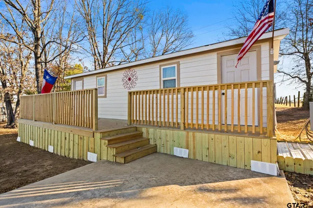 a view of a house with a wooden fence