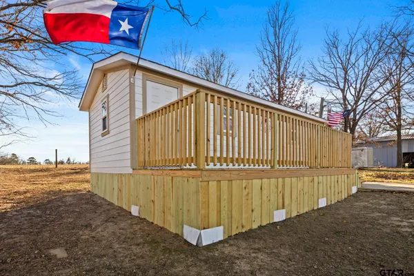 a view of a street with wooden fence