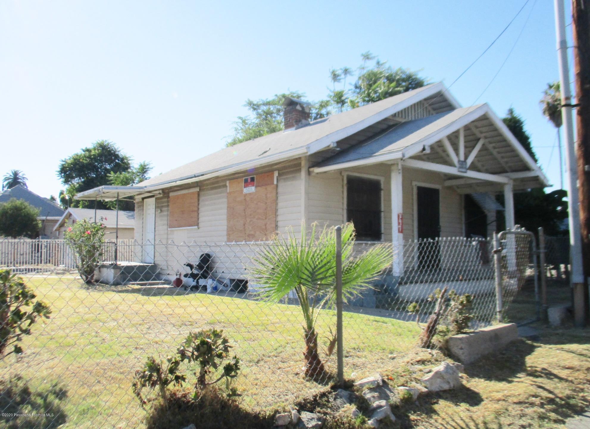 396 North Summit Avenue Pasadena, CA 91103 - Photo 11 of 12 a front view of a house with a yard outdoor seating and covered with trees
