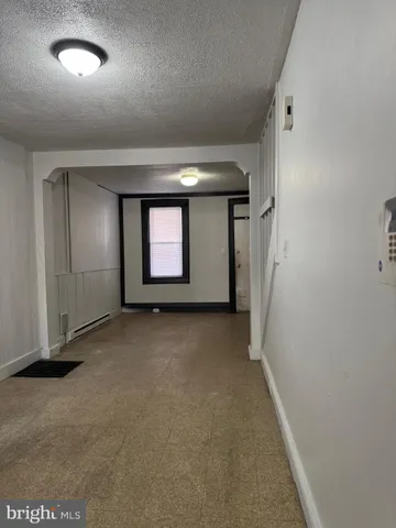 an empty room with a empty space and windows