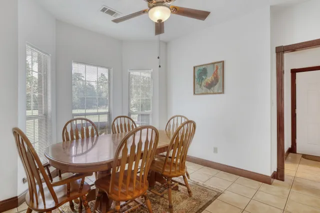 a view of a dining room with furniture and window