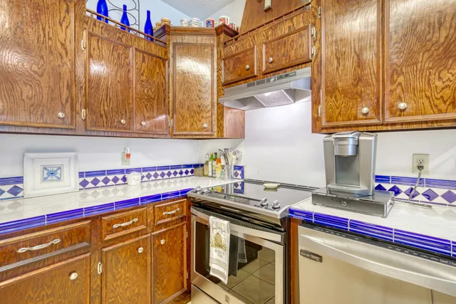 a kitchen with stainless steel appliances granite countertop a sink and cabinets