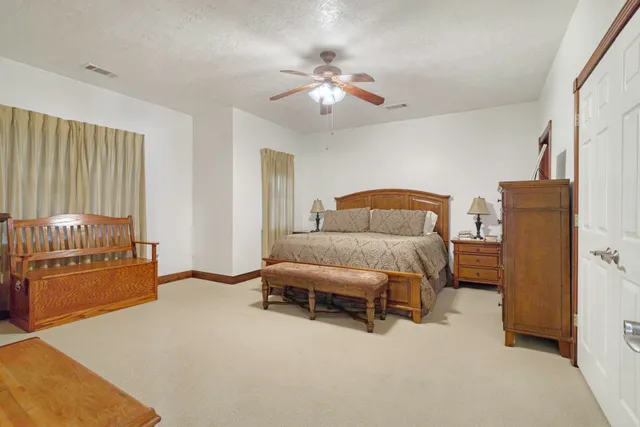 a bedroom with a bed and window