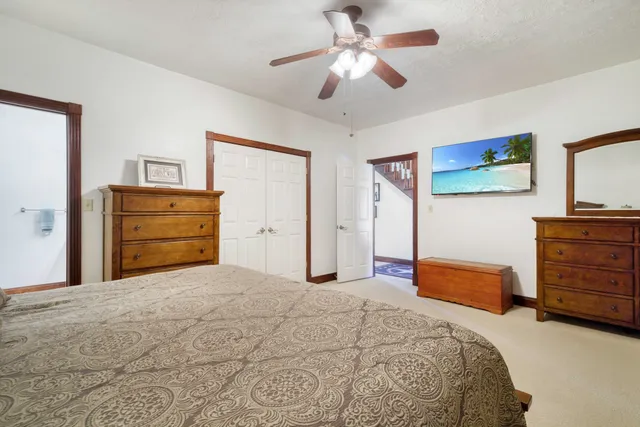 a bedroom with a bed and a dresser