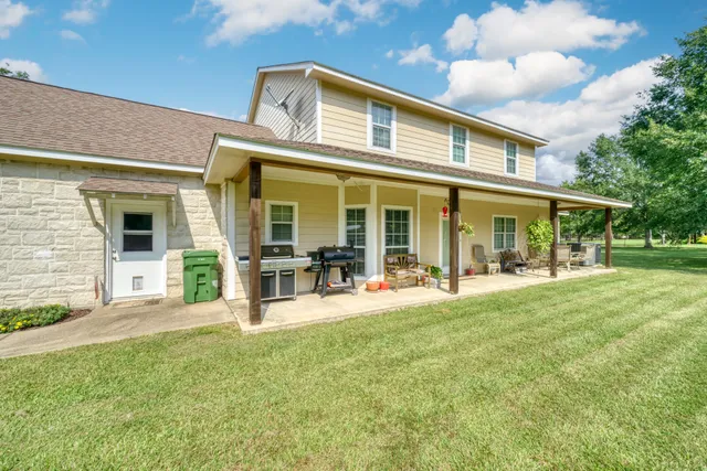 a front view of house with yard patio and green space